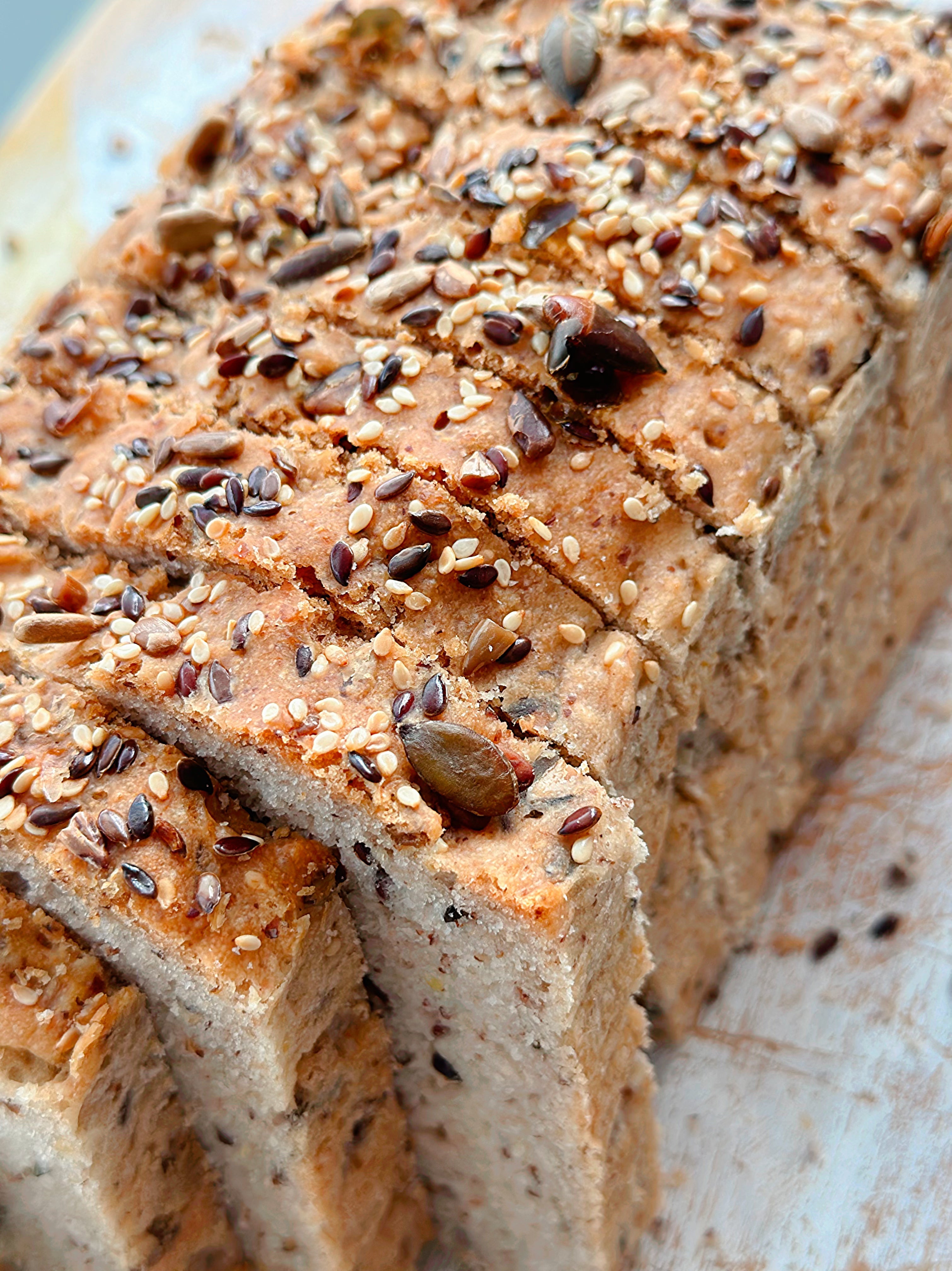Sliced gluten-free wholegrain bread with seeds visible in the crumb, from our breads collection at Gluten Tag in Copenhagen.