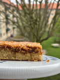 Slice of gluten-free milk-free drømmekage with golden coconut caramel topping on vanilla sponge, the Danish classic baked by Gluten Tag in Copenhagen.