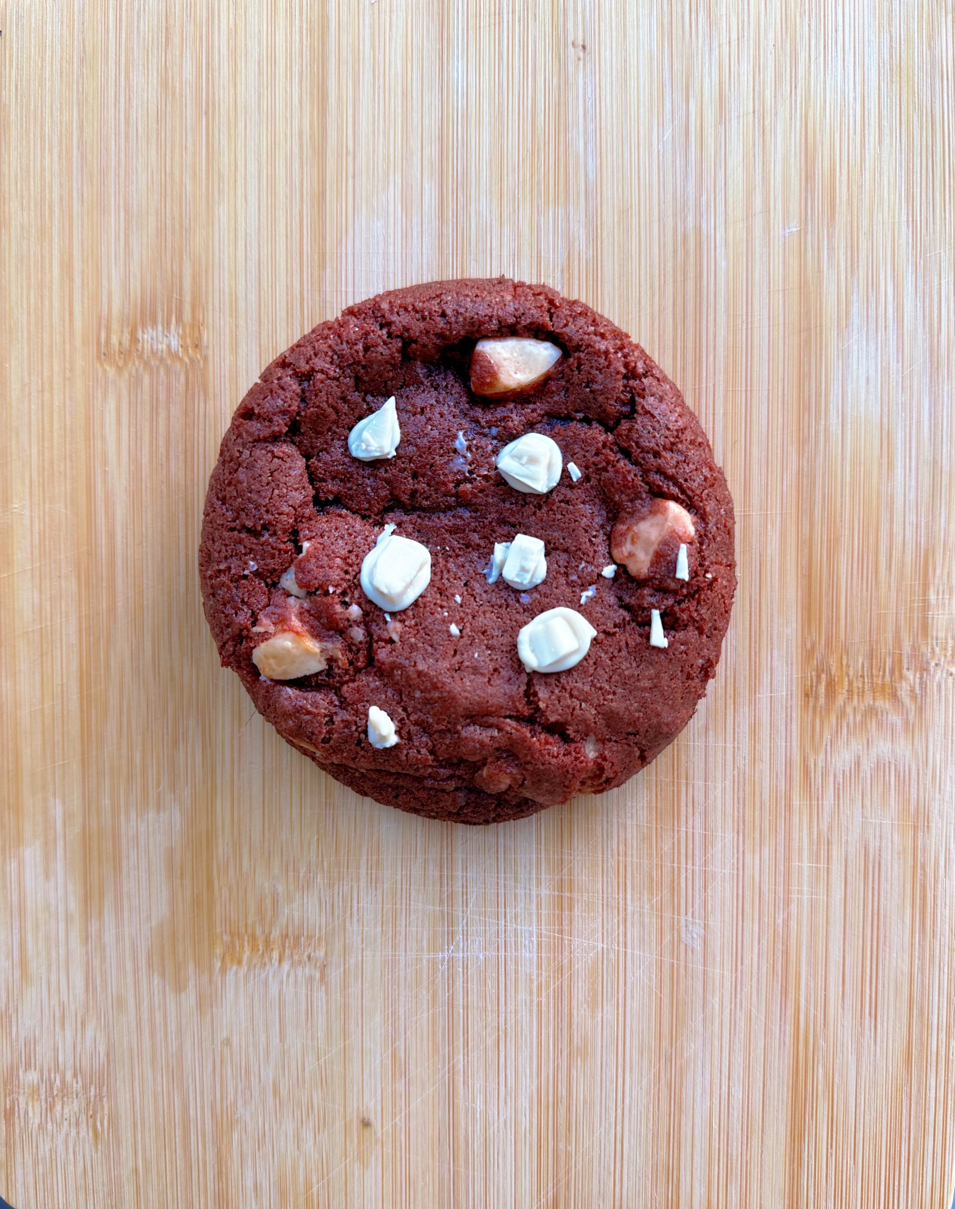 Stack of vegan gluten-free red velvet cookies with vegan white chocolate chunks, baked thick and fudgy by Gluten Tag in Copenhagen.